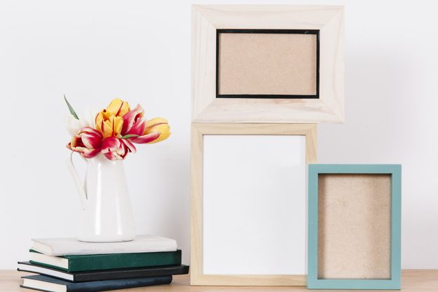 arranged-photo-frames-on-table_23-2147755043